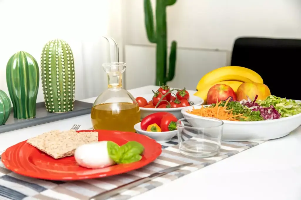A cozy kitchen scene with a stack of soft, nourishing foods on a wooden table. In the foreground, a plate showcases a variety of easily digestible ingredients - steamed vegetables, lean proteins, and whole grains. Soft lighting from a nearby window casts a warm glow, creating a calming, comforting atmosphere. In the background, kitchen utensils and appliances suggest a well-equipped space for preparing a post-surgery recovery diet. The overall composition emphasizes the importance of a thoughtfully curated, nutritious meal plan during the healing process after prostate surgery. A cozy kitchen scene with a stack of soft, nourishing foods on a wooden table. In the foreground, a plate showcases a variety of easily digestible ingredients - steamed vegetables, lean proteins, and whole grains. Soft lighting from a nearby window casts a warm glow, creating a calming, comforting atmosphere. In the background, kitchen utensils and appliances suggest a well-equipped space for preparing a post-surgery recovery diet. The overall composition emphasizes the importance of a thoughtfully curated, nutritious meal plan during the healing process after prostate surgery.