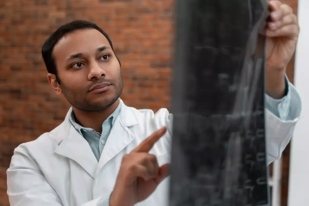 A detailed, high-resolution illustration of a brain biopsy procedure. In the foreground, a neurosurgeon in sterile surgical attire carefully guides a biopsy needle into the patient's exposed brain, with precise anatomical details visible. The middle ground shows a team of medical professionals monitoring the procedure, their faces obscured by surgical masks. The background depicts a modern operating theater with high-intensity lighting, advanced medical equipment, and a sense of clinical sterility. The overall mood is one of focused professionalism and technical precision, conveying the gravity and complexity of the delicate brain biopsy process. A detailed, high-resolution illustration of a brain biopsy procedure. In the foreground, a neurosurgeon in sterile surgical attire carefully guides a biopsy needle into the patient's exposed brain, with precise anatomical details visible. The middle ground shows a team of medical professionals monitoring the procedure, their faces obscured by surgical masks. The background depicts a modern operating theater with high-intensity lighting, advanced medical equipment, and a sense of clinical sterility. The overall mood is one of focused professionalism and technical precision, conveying the gravity and complexity of the delicate brain biopsy process.