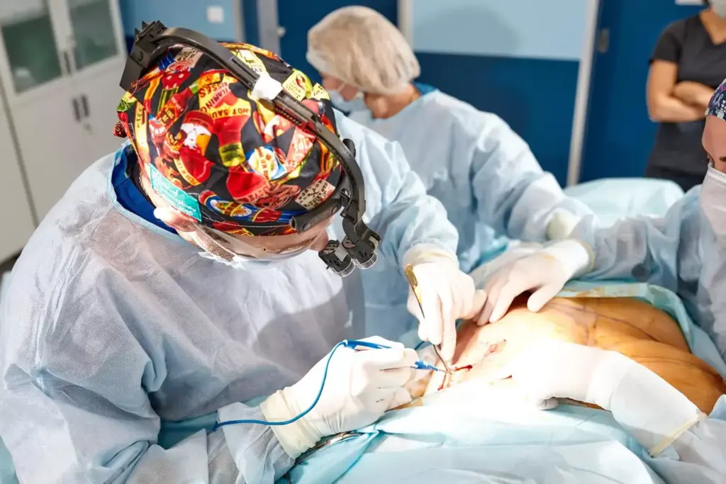 A detailed medical illustration of a myomectomy procedure. The foreground depicts the uterus with visible fibroids being carefully excised by a skilled surgeon using precise surgical instruments. The middle ground shows the surgical team working diligently, wearing sterile gowns and using advanced laparoscopic techniques. The background features the well-lit, modern operating room with state-of-the-art medical equipment. The overall scene conveys a sense of clinical expertise, patient care, and the complexity of the myomectomy procedure. The lighting is bright and natural, capturing the intricate details of the anatomy and surgical instruments. The camera angle provides a clear, informative view of the procedure. A detailed medical illustration of a myomectomy procedure. The foreground depicts the uterus with visible fibroids being carefully excised by a skilled surgeon using precise surgical instruments. The middle ground shows the surgical team working diligently, wearing sterile gowns and using advanced laparoscopic techniques. The background features the well-lit, modern operating room with state-of-the-art medical equipment. The overall scene conveys a sense of clinical expertise, patient care, and the complexity of the myomectomy procedure. The lighting is bright and natural, capturing the intricate details of the anatomy and surgical instruments. The camera angle provides a clear, informative view of the procedure.