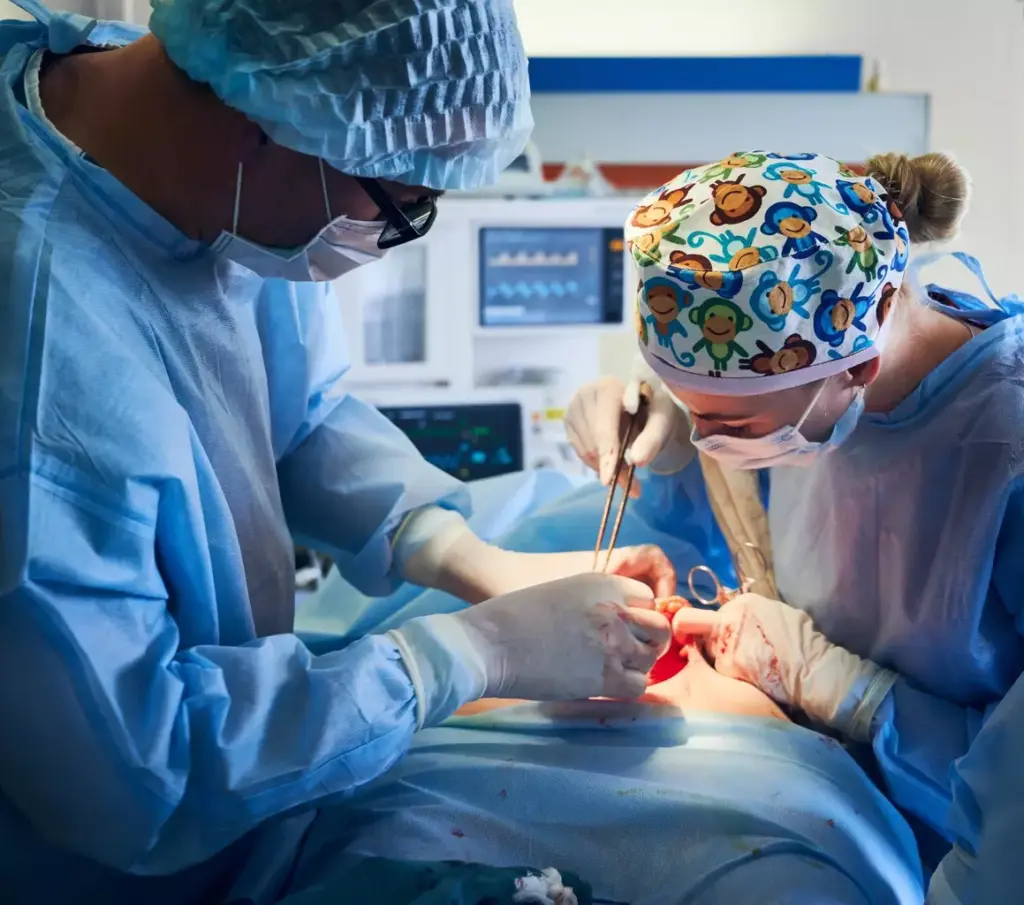 A detailed surgical scene depicting a double knee replacement operation in progress. In the foreground, the surgeon's gloved hands meticulously manipulate surgical instruments, expertly exposing and reshaping the knee joints. In the middle ground, a clear view of the open surgical site reveals the precise incisions and implants being carefully installed. The background showcases the sterile, well-lit operating theater, with medical staff attentively monitoring the procedure. The lighting is bright and clinical, casting a sense of focused intensity. The overall mood conveys the gravity and technical precision of this delicate orthopedic surgery. A detailed surgical scene depicting a double knee replacement operation in progress. In the foreground, the surgeon's gloved hands meticulously manipulate surgical instruments, expertly exposing and reshaping the knee joints. In the middle ground, a clear view of the open surgical site reveals the precise incisions and implants being carefully installed. The background showcases the sterile, well-lit operating theater, with medical staff attentively monitoring the procedure. The lighting is bright and clinical, casting a sense of focused intensity. The overall mood conveys the gravity and technical precision of this delicate orthopedic surgery.