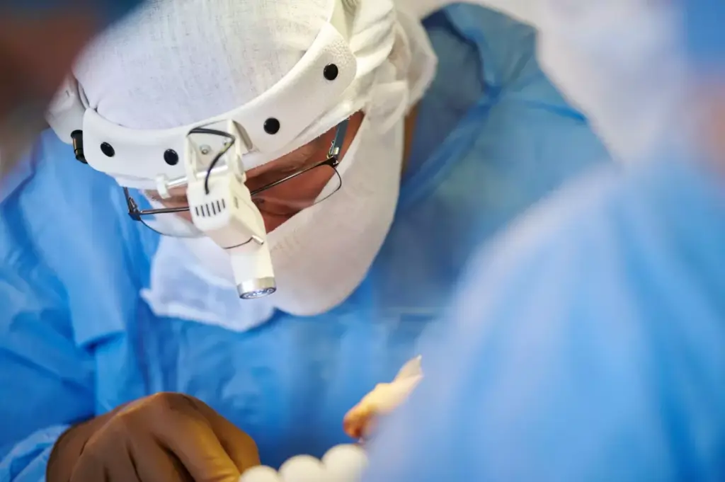 A detailed surgical view of a cervical fusion procedure. In the foreground, a skilled surgeon's hands manipulate specialized medical instruments, delicately repositioning vertebrae. The middle ground reveals the intricate anatomy of the cervical spine, with bones, discs, and nerves illuminated under bright surgical lights. The background showcases a modern operating room, with gleaming medical equipment and a serene, clinical atmosphere. The scene conveys the precision, expertise, and care required to perform this complex spinal surgery, which aims to alleviate neck pain and restore mobility. A detailed surgical view of a cervical fusion procedure. In the foreground, a skilled surgeon's hands manipulate specialized medical instruments, delicately repositioning vertebrae. The middle ground reveals the intricate anatomy of the cervical spine, with bones, discs, and nerves illuminated under bright surgical lights. The background showcases a modern operating room, with gleaming medical equipment and a serene, clinical atmosphere. The scene conveys the precision, expertise, and care required to perform this complex spinal surgery, which aims to alleviate neck pain and restore mobility.