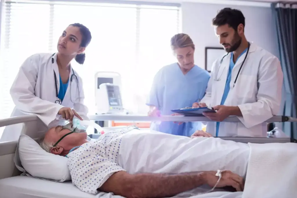 A man in a hospital gown lying on a hospital bed, recovering from a prostate surgery. The foreground shows the patient's upper body, with bandages and tubes visible. The middle ground features medical equipment and a nurse attending to the patient. The background is a dimly lit hospital room with curtains drawn. Soft, warm lighting illuminates the scene, creating a serene and calming atmosphere. The overall tone conveys the patient's gradual recovery process, with a sense of care and support provided by the medical staff.