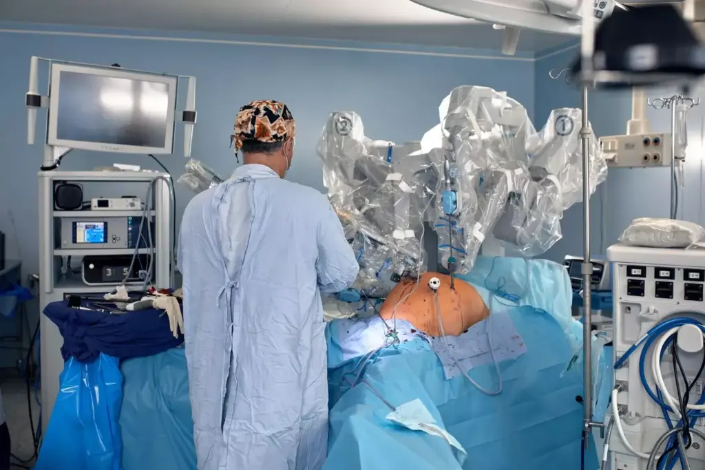 A sophisticated surgical suite illuminated by warm overhead lighting. In the center, a sleek robotic arm, the da Vinci system, poised over a patient's abdomen, its metallic limbs delicately performing a minimally invasive hysterectomy procedure. Surrounding the robotic surgeon, a team of medical professionals monitor the operation, their faces reflecting the precision and care required for this technological evolution in women's healthcare. In the background, state-of-the-art medical equipment and monitors provide real-time data, guiding the surgeon's hands through this delicate procedure. The scene conveys the seamless integration of robotic technology and human skill, revolutionizing the future of hysterectomy. A sophisticated surgical suite illuminated by warm overhead lighting. In the center, a sleek robotic arm, the da Vinci system, poised over a patient's abdomen, its metallic limbs delicately performing a minimally invasive hysterectomy procedure. Surrounding the robotic surgeon, a team of medical professionals monitor the operation, their faces reflecting the precision and care required for this technological evolution in women's healthcare. In the background, state-of-the-art medical equipment and monitors provide real-time data, guiding the surgeon's hands through this delicate procedure. The scene conveys the seamless integration of robotic technology and human skill, revolutionizing the future of hysterectomy.