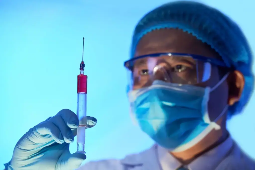 A sterile, clinical laboratory setting with modern medical equipment. In the foreground, a vial of clear liquid and syringes, representing the ABVD chemotherapy drugs. In the middle ground, a patient's arm with an intravenous line, symbolizing the administration of the treatment. The background features a medical chart or diagram illustrating the ABVD regimen and its effects on the body. Soft, neutral lighting casts a contemplative mood, emphasizing the importance and complexity of this cancer treatment. Detailed, realistic depiction using a wide-angle lens to capture the full scene. A sterile, clinical laboratory setting with modern medical equipment. In the foreground, a vial of clear liquid and syringes, representing the ABVD chemotherapy drugs. In the middle ground, a patient's arm with an intravenous line, symbolizing the administration of the treatment. The background features a medical chart or diagram illustrating the ABVD regimen and its effects on the body. Soft, neutral lighting casts a contemplative mood, emphasizing the importance and complexity of this cancer treatment. Detailed, realistic depiction using a wide-angle lens to capture the full scene.