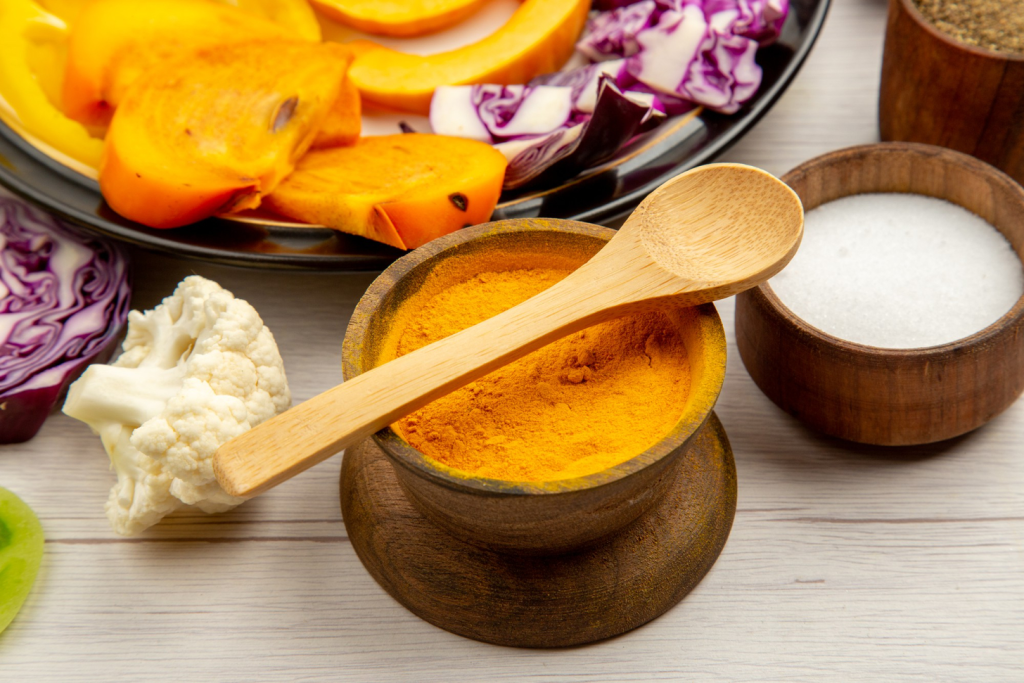A vibrant, close-up photograph of fresh turmeric root and ground curcumin powder against a soft, out-of-focus background. The turmeric root is sliced in half, revealing its golden-orange flesh. The curcumin powder is presented in a small ceramic bowl, its warm, earthy tones complementing the turmeric. Soft, natural lighting illuminates the scene, casting a gentle glow and creating a sense of harmony. The overall composition highlights the medicinal properties of these natural ingredients and their potential benefits for ovarian cancer treatment.