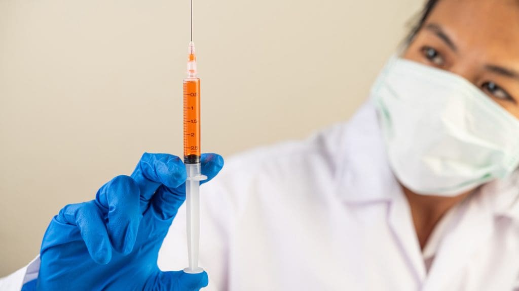 Doctor holding needle