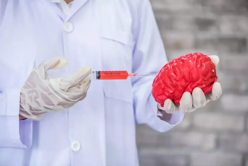 Doctor injecting medication into artifical brain model