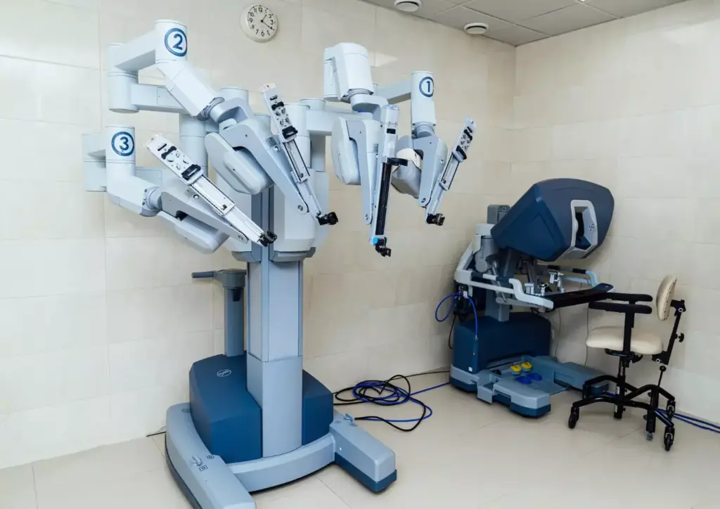 Intricate surgical robot with sleek, modern design. Prominent central console with multiple articulated arms and advanced instruments. Surrounded by detailed machinery, sensors, and control panels. Bright, clinical lighting illuminates the scene from above. High-resolution, photorealistic depiction from a slightly elevated angle, capturing the scale and complexity of the Da Vinci Xi Surgical System. Conveys the advanced, state-of-the-art nature of this robotic technology for minimally invasive surgery. Intricate surgical robot with sleek, modern design. Prominent central console with multiple articulated arms and advanced instruments. Surrounded by detailed machinery, sensors, and control panels. Bright, clinical lighting illuminates the scene from above. High-resolution, photorealistic depiction from a slightly elevated angle, capturing the scale and complexity of the Da Vinci Xi Surgical System. Conveys the advanced, state-of-the-art nature of this robotic technology for minimally invasive surgery.